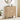 Wooden cabinet with circular design in a room with a plant and mirror.