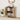 Wooden cabinet with open doors displaying books, decor items, and a plant in a room.