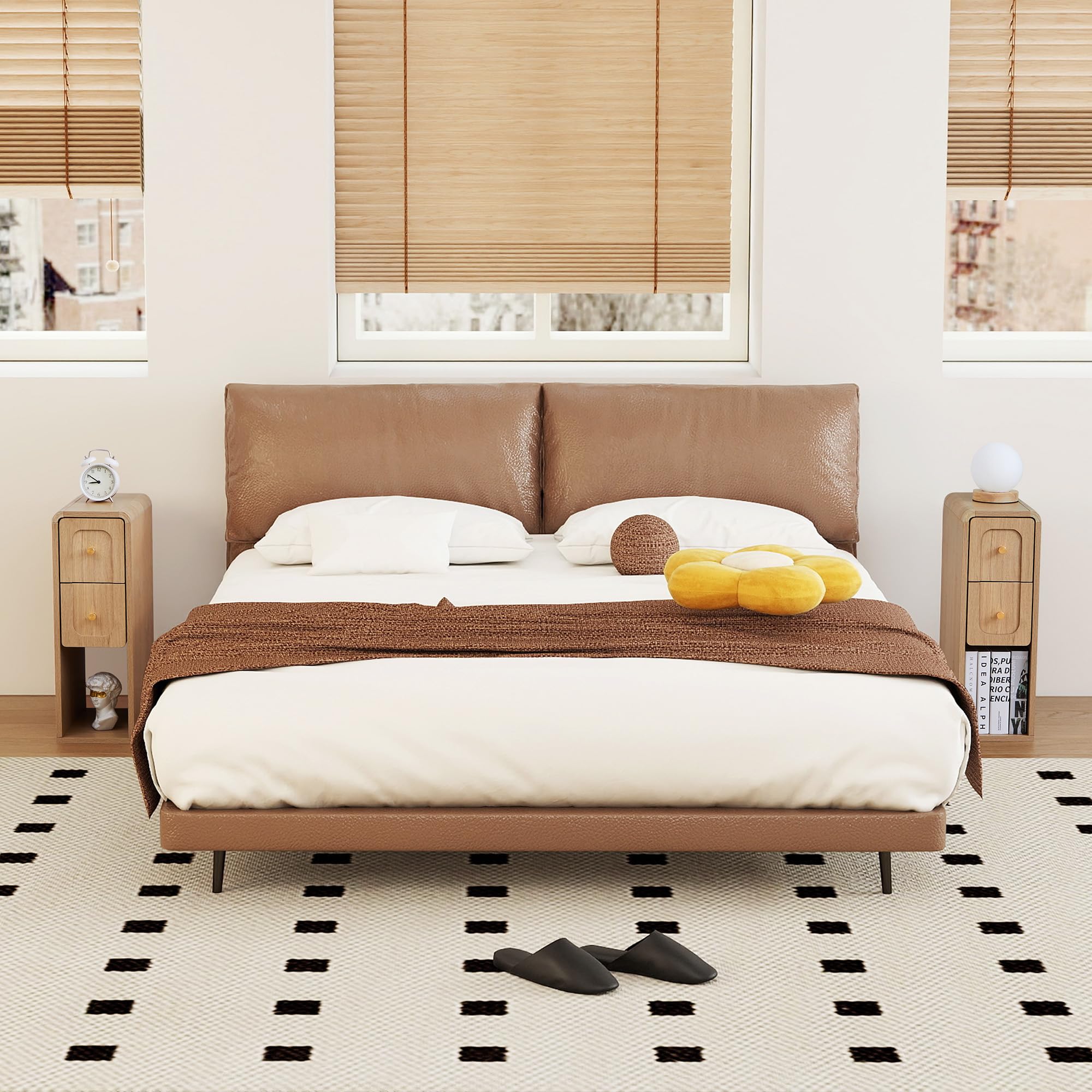 Modern bedroom with a brown leather bed, nightstands, and decorative items.