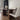 Dining room with a wooden table and white chairs.