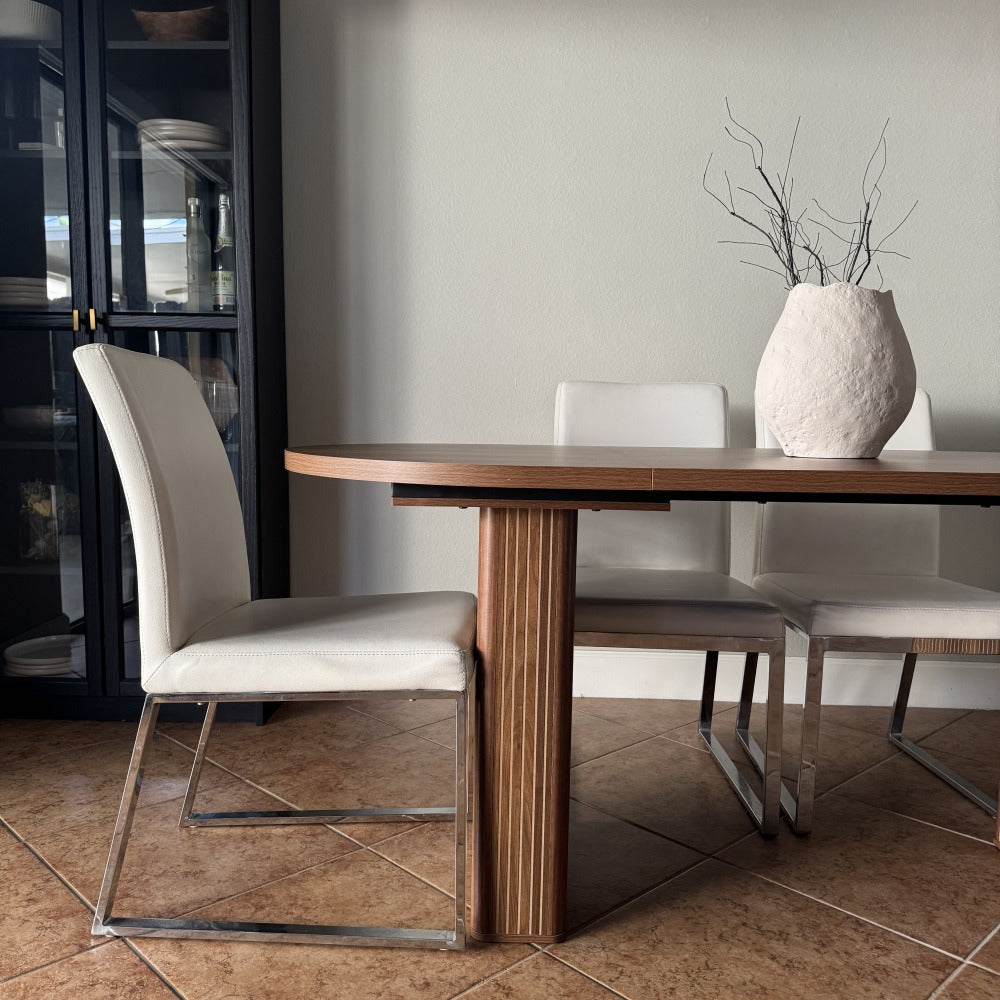 Dining area with a wooden table and chairs in a modern interior setting.