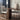 Dining table with chairs and a vase in a modern interior setting