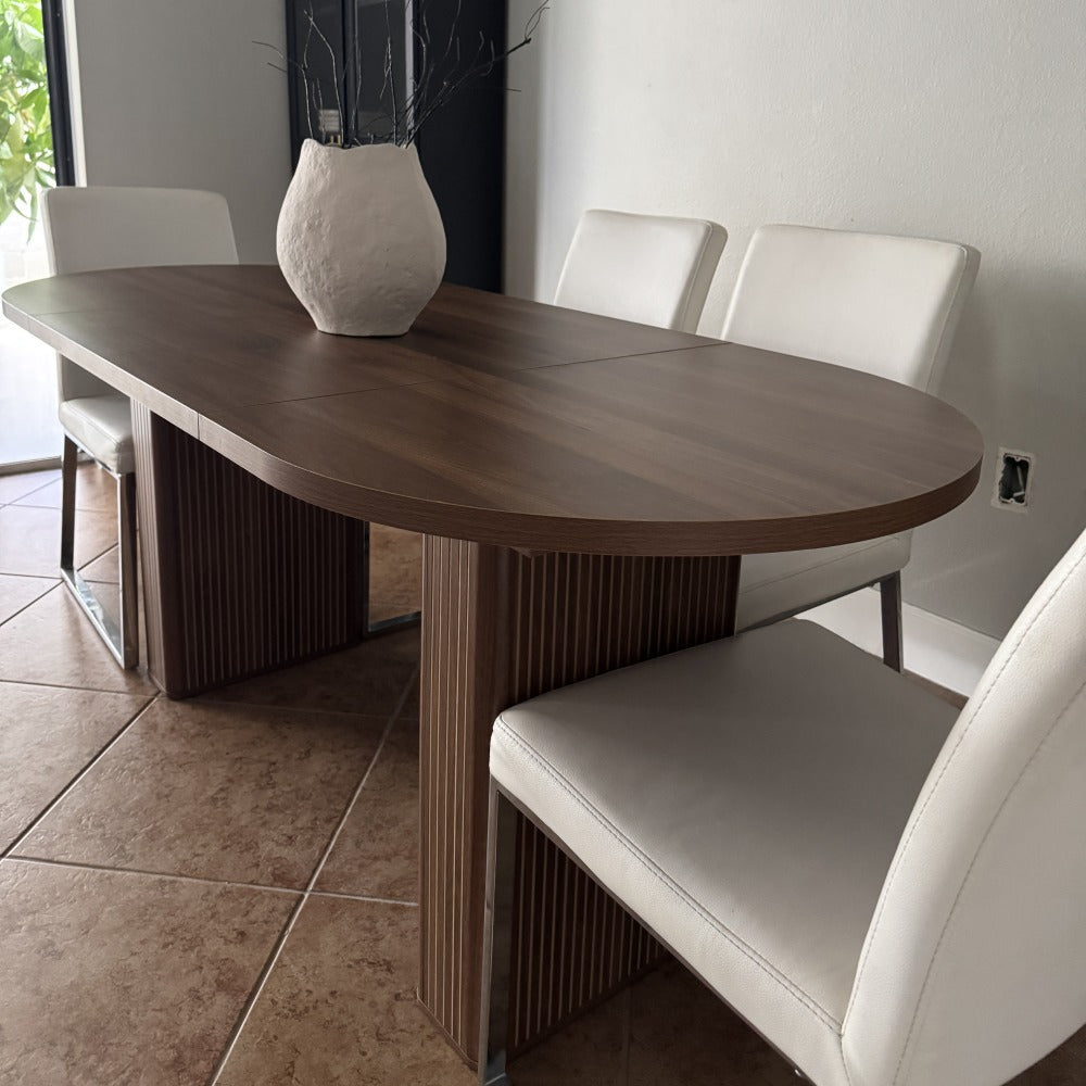 Dining table with white chairs in a modern interior setting