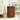 Wooden side table with decorative items in a living room setting