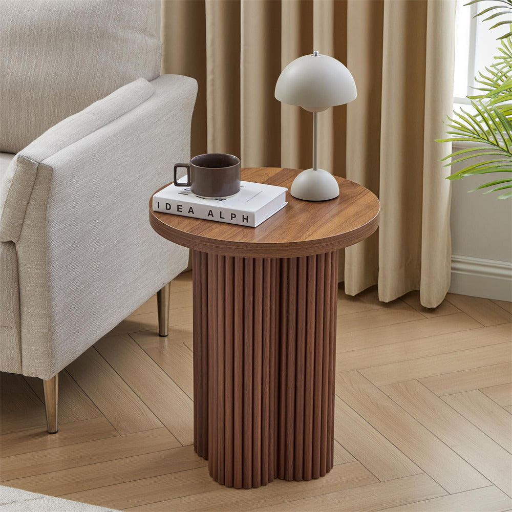 Wooden side table with a lamp and mug in a living room setting