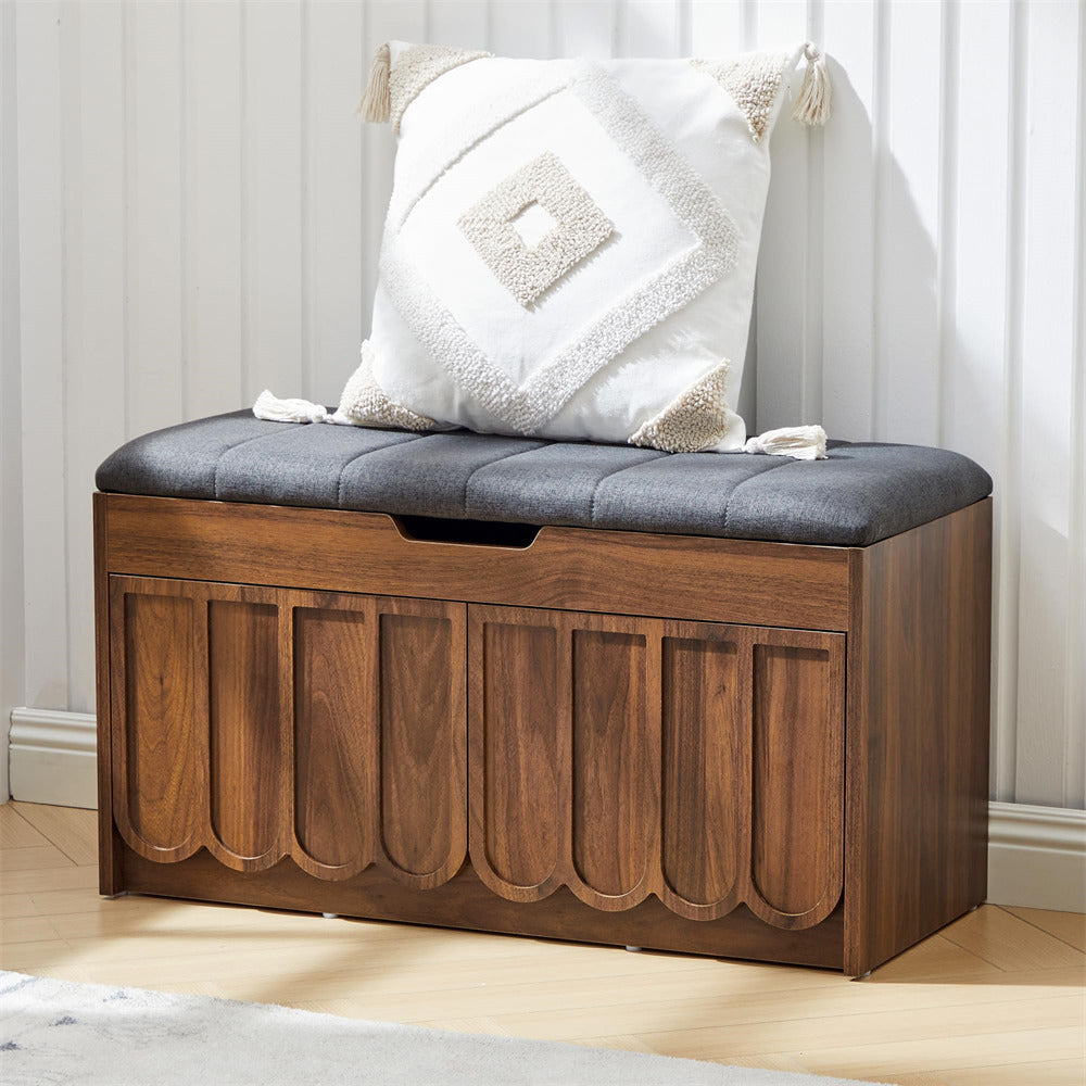 Wooden shoe storage bench with a cushion and decorative pillow in a room setting.