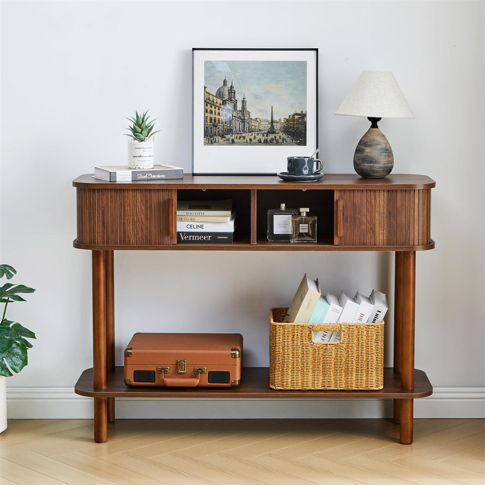 Wooden console table with decorative items against a white wall