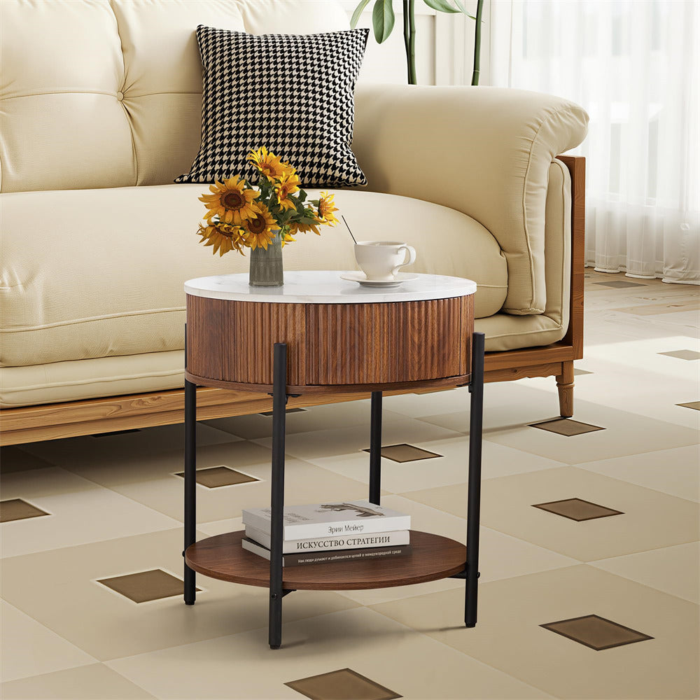 Round wooden coffee table with a vase of sunflowers and books in a living room setting.