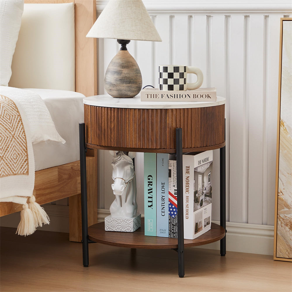 Wooden side table with books and decor items next to a bed
