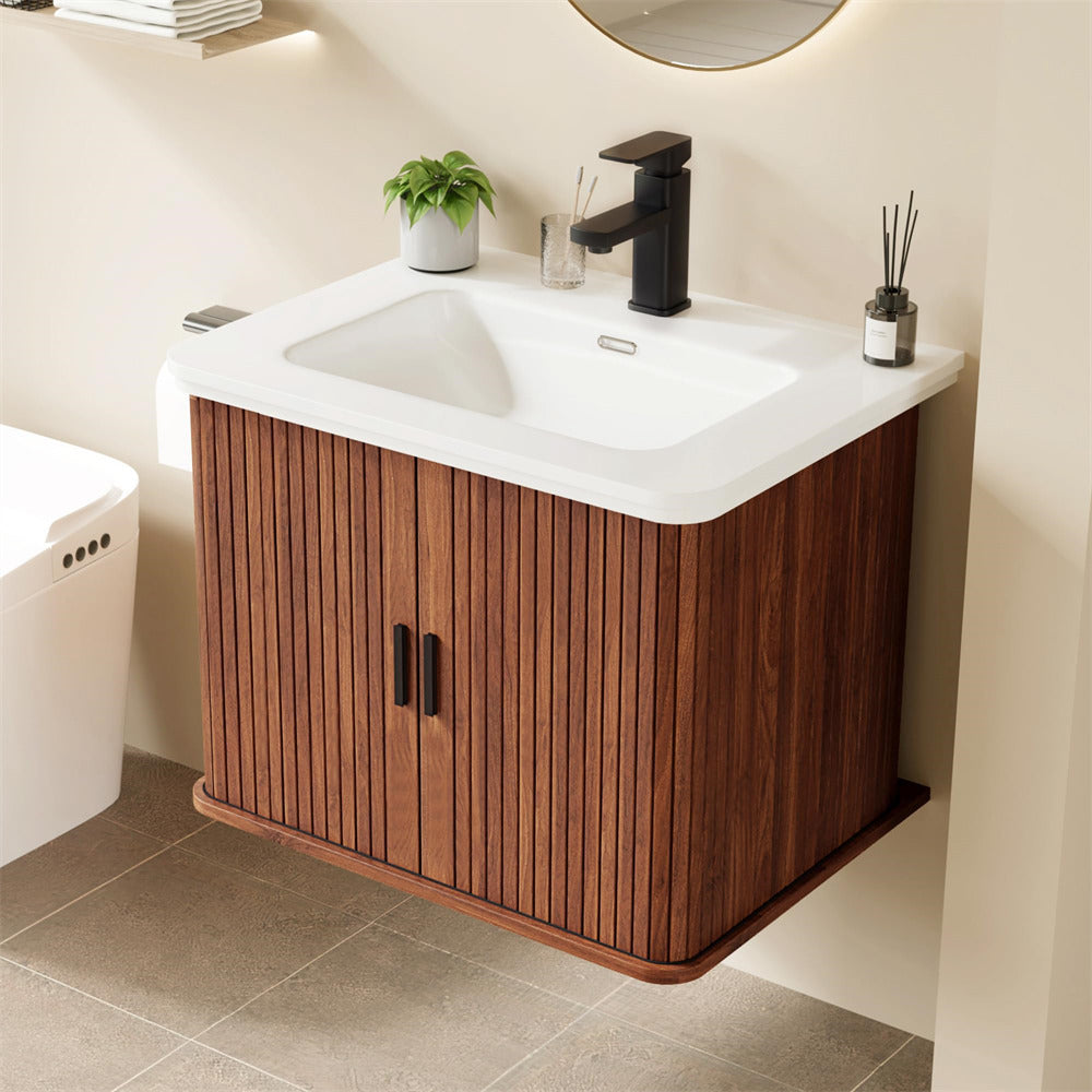 Bathroom vanity with wooden cabinet, white sink, and black faucet.