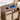 Wooden charging station with electronic devices and power outlets on a wooden table.
