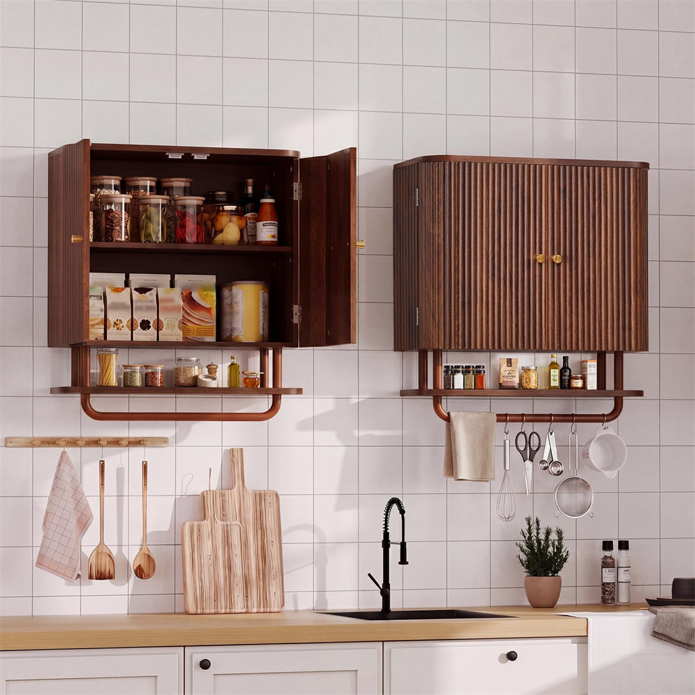 Two dark brown wooden wall-mounted kitchen cabinets with open and closed doors, shown installed on a white tiled kitchen wall above a countertop with jars, utensils, and a sink.