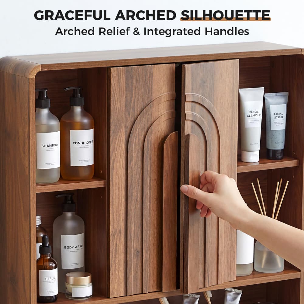 A wooden bathroom cabinet with two arched doors and integrated handles, shown open with shelves holding toiletries. A human hand is touching the right door handle, and text at the top reads 'GRACEFUL ARCHED SILHOUETTE' and 'Arched Relief & Integrated Handles.