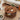 Round wooden coffee table with decorative items in a living room setting
