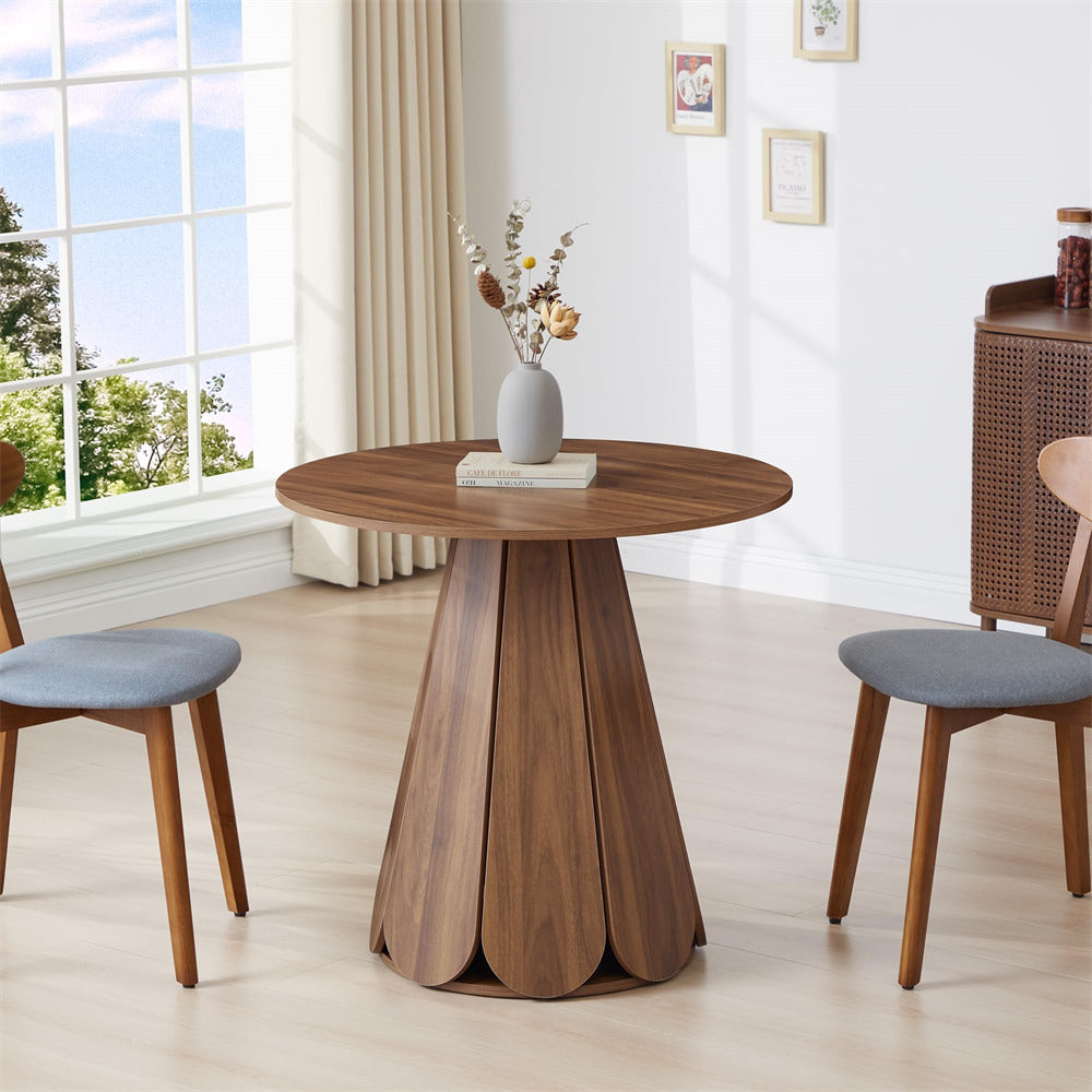 Wooden dining table with chairs in a bright room with large windows.
