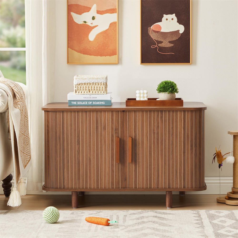 Wooden cat litter box in a room with cat-themed decor and toys on the floor.