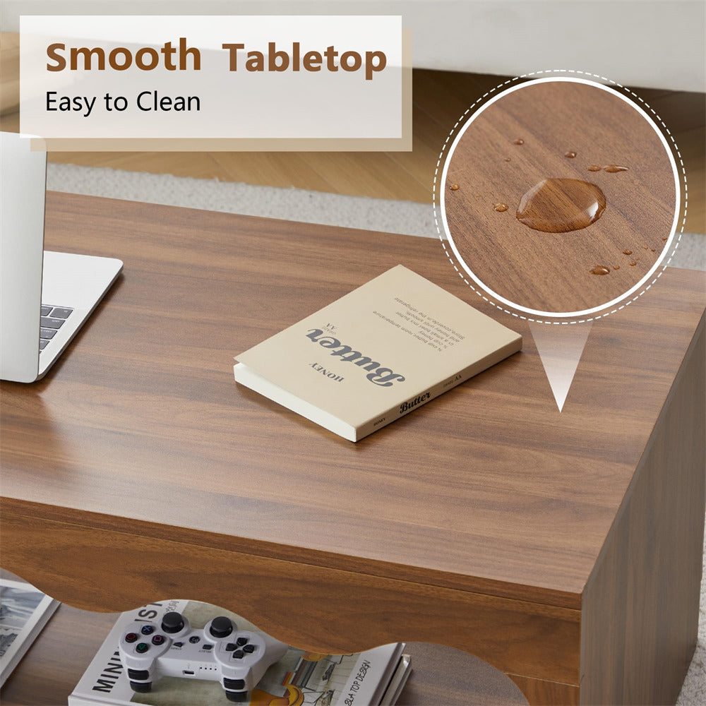 Wooden desk with a laptop, notebook, and remote control with a close-up of a smooth tabletop.