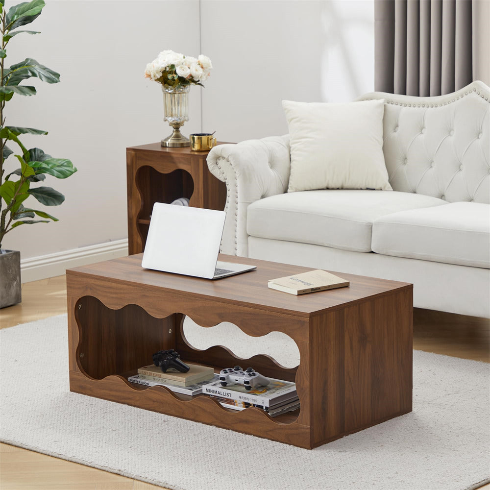 Wooden coffee table in a living room with a laptop, books, and decorative items.