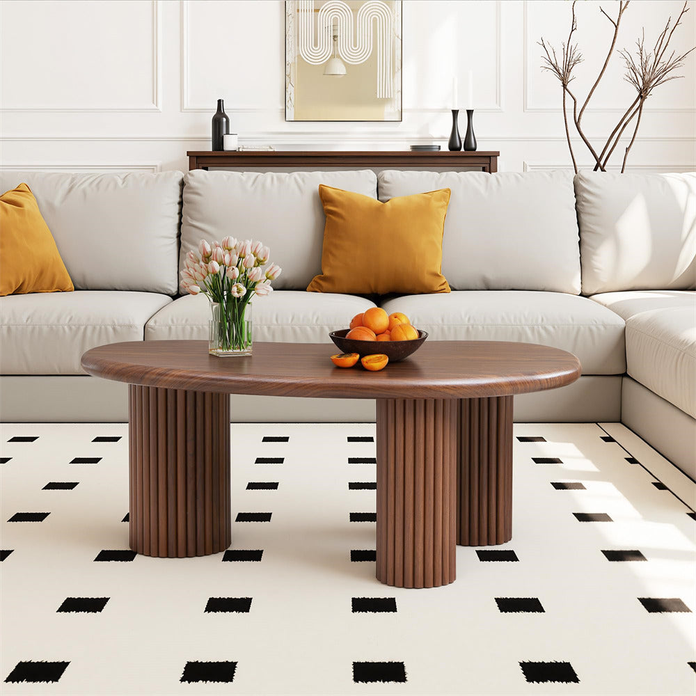 Modern living room with a sectional sofa, wooden coffee table, and decorative elements.