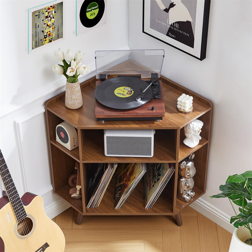 Wooden record player shelf with vinyl records, speakers, and a guitar in a room setting.