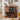 Wooden record player console with vinyl records and speakers in a room.