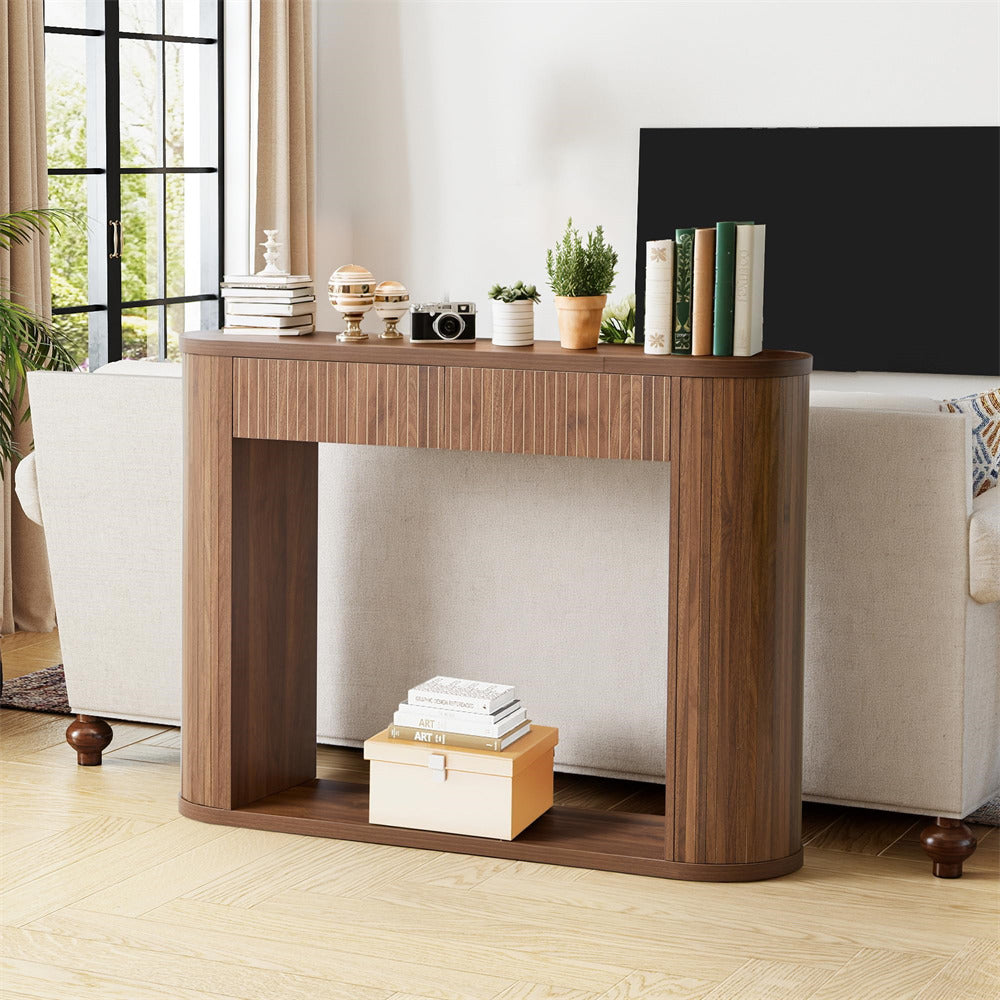 Wooden console table in a living room setting with decor items.