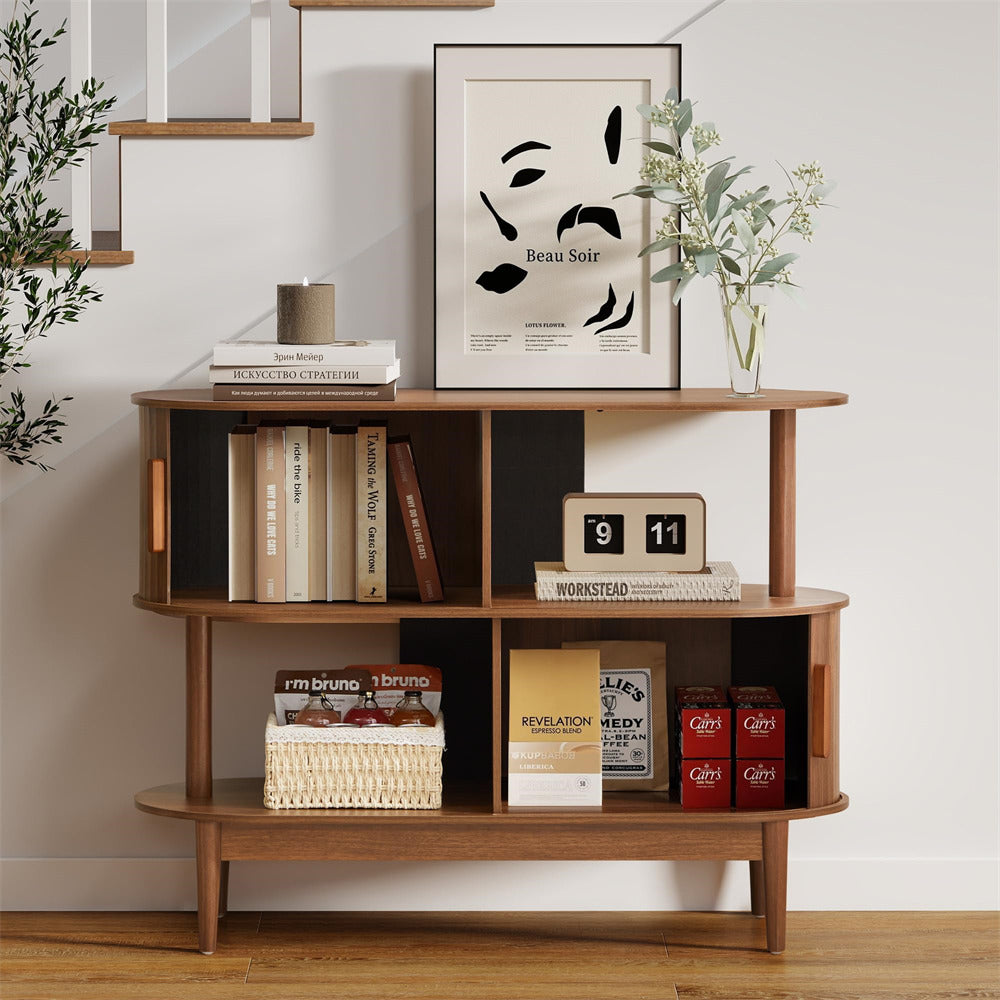 Wooden shelf with books, a calendar, and decorative items against a white wall.