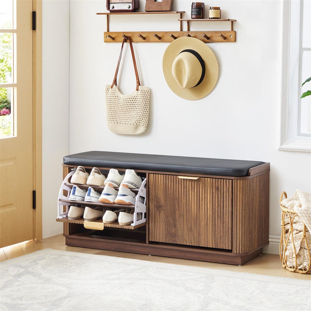 Wooden shoe bench with open drawer displaying shoes, hat, and bag in a room.