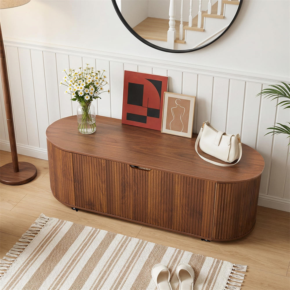Wooden console table with decorative items in a room with a mirror and lamp.