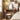 Wooden vanity table with mirror and stool in a bedroom setting