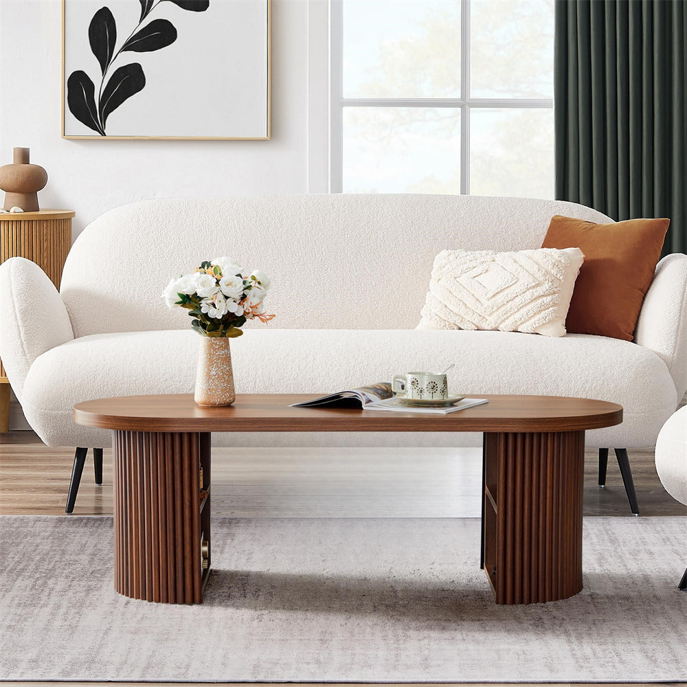 Modern living room with a white sofa, wooden coffee table, and decorative items.