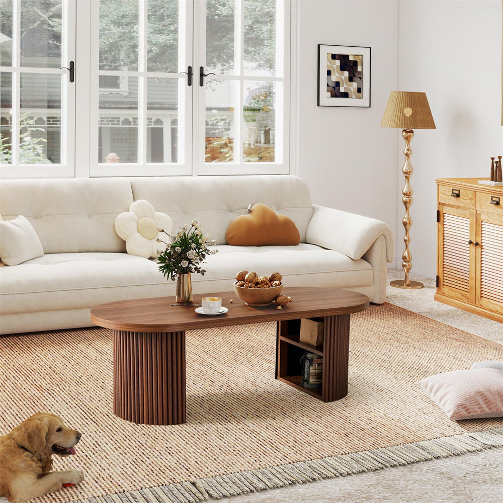 Living room with a white sofa, wooden coffee table, and decorative items.