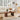 Living room with a white sofa, wooden coffee table, and decorative items.