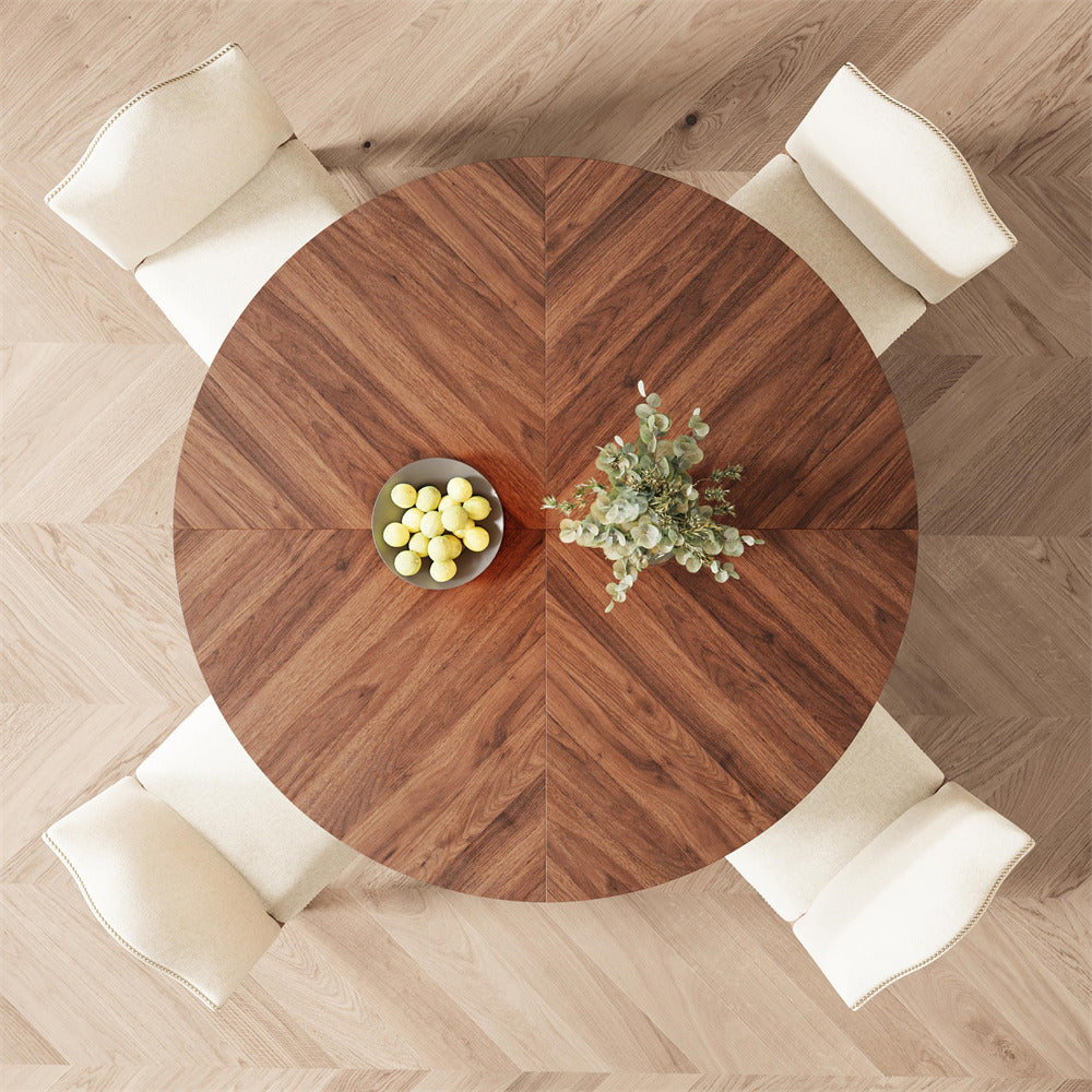 Round wooden table with decorative items in a room with wooden flooring.