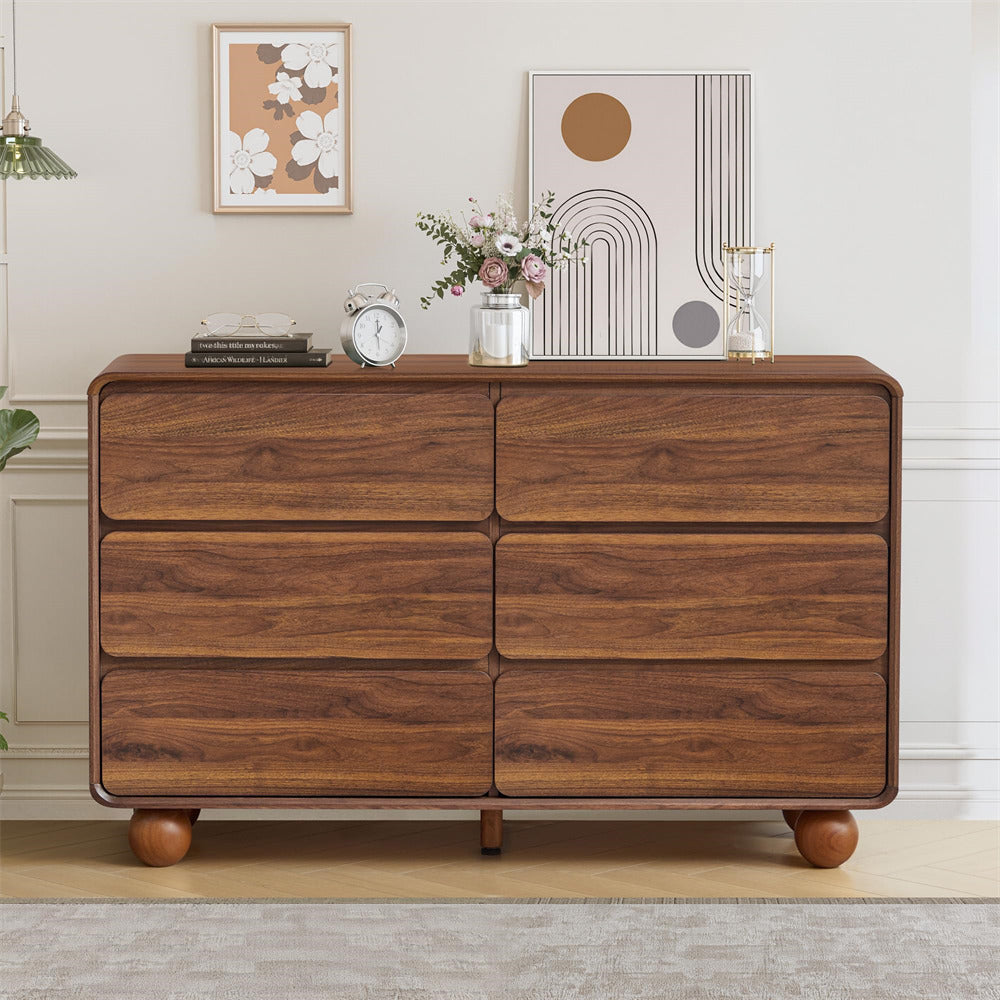 Wooden dresser with decorative items in a room setting