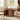Wooden dining table with chairs in a room with a painting on the wall.