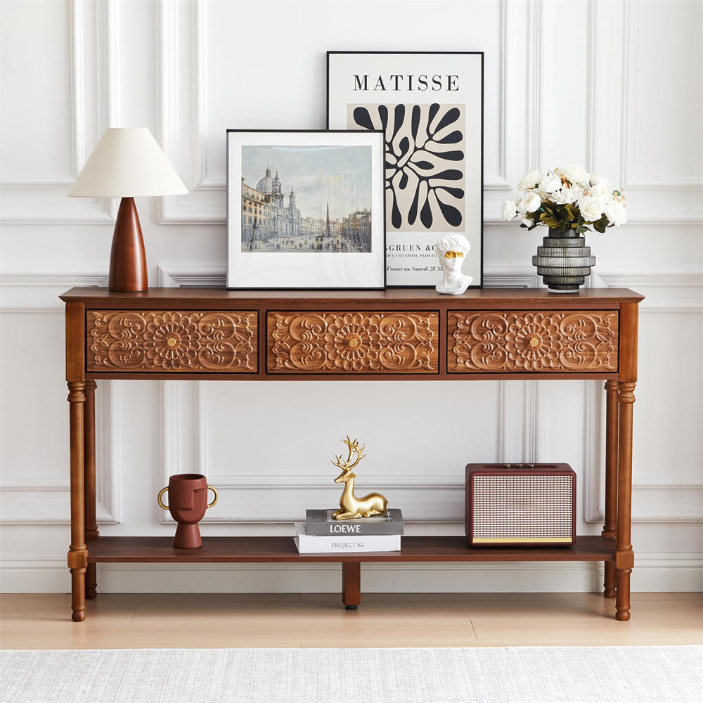 Decorative wooden console table with various items against a white wall.
