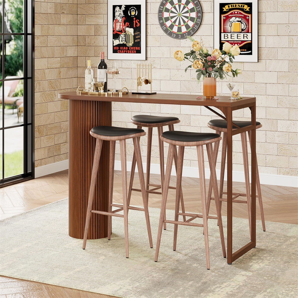 Wooden bar set with stools in a room with a dartboard and beer-themed decor.