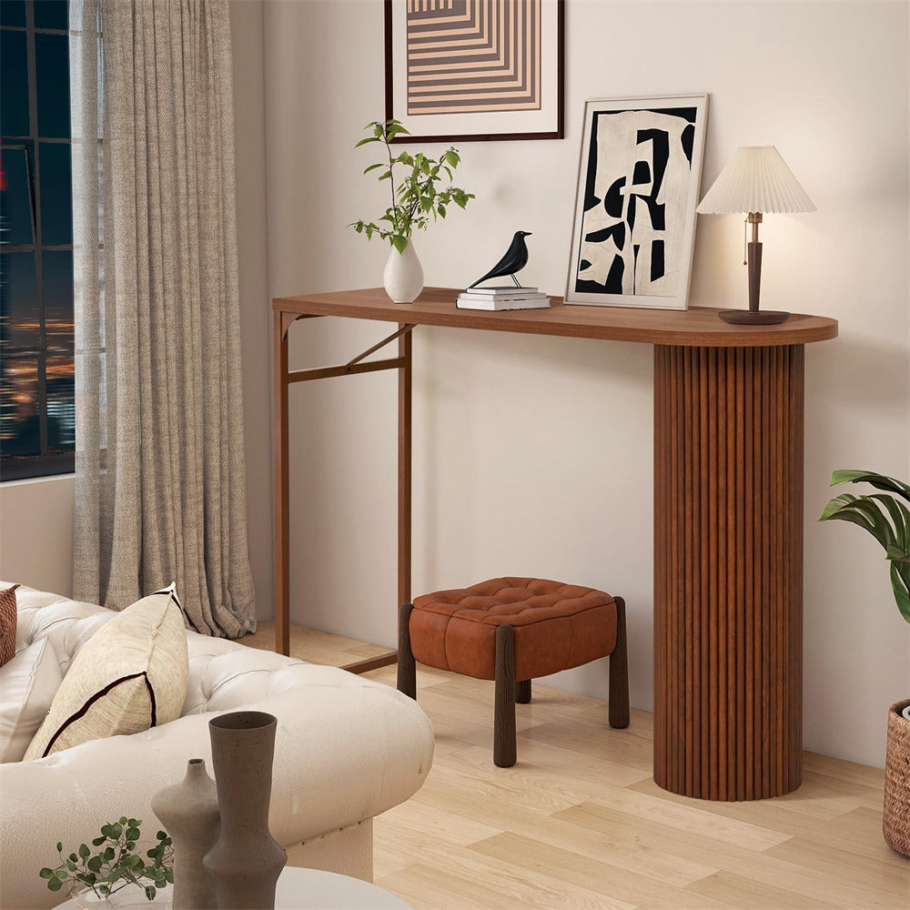 Wooden console table in a living room setting with decor items.