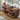 Wooden record player console with vinyl records and a turntable on a wooden floor.
