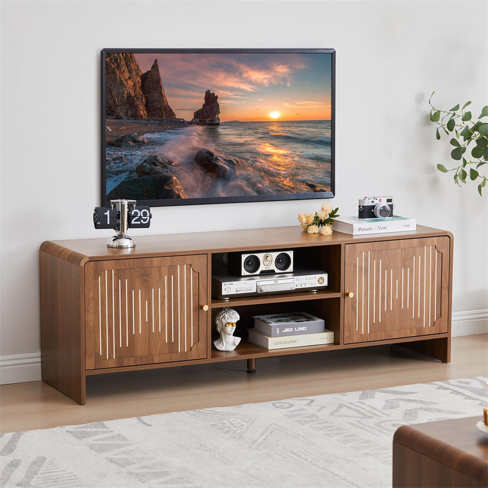Wooden TV stand with a television displaying a sunset over water scene, placed in a living room.