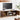 Wooden TV stand with storage compartments in a living room setting, emphasizing storage space.