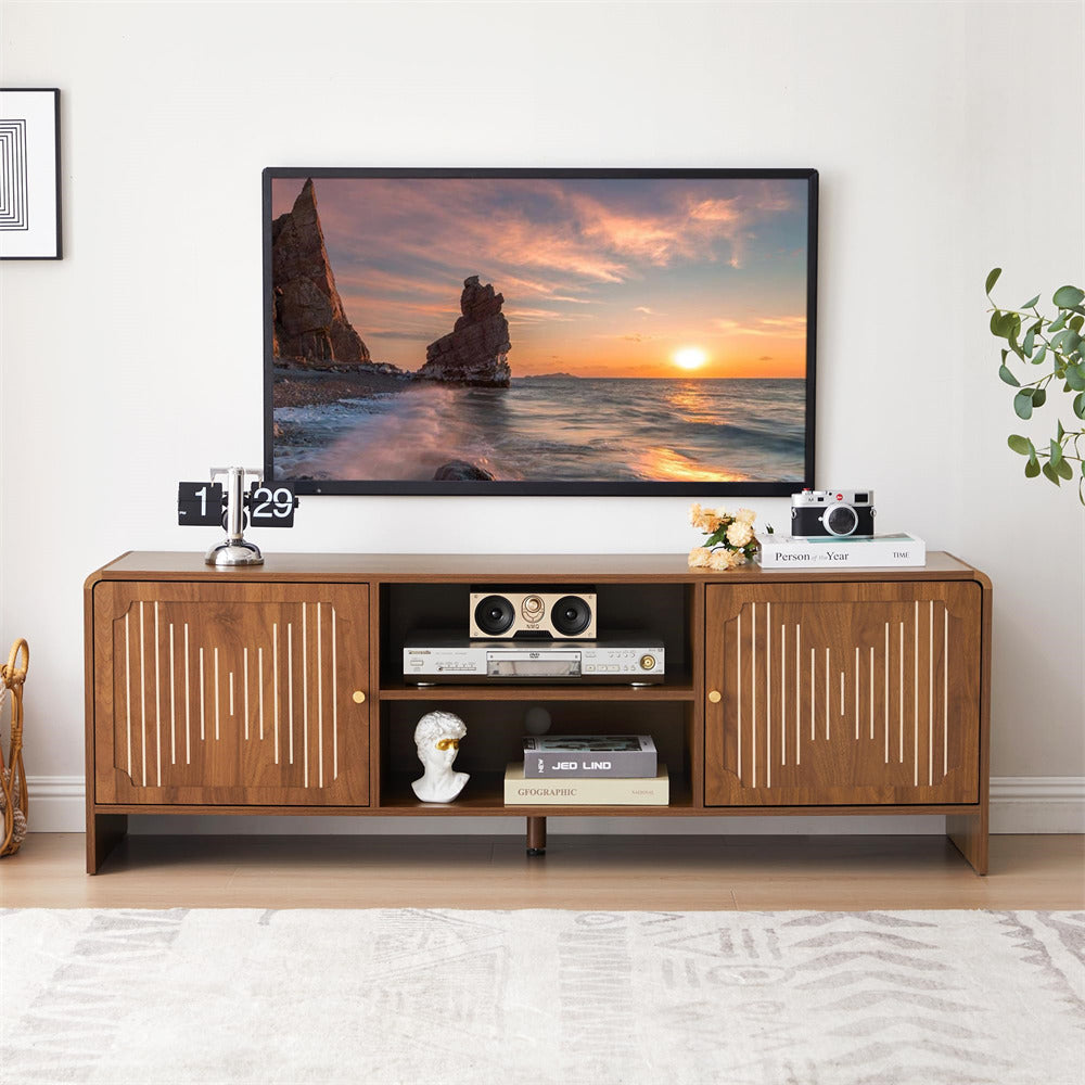 Wooden TV stand with a television displaying a sunset scene, surrounded by decorative items.