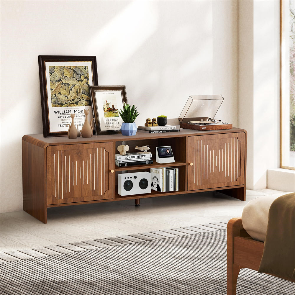 Wooden entertainment console in a living room with decor items.