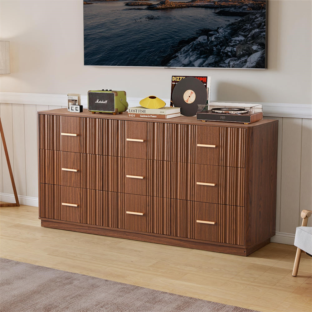 Wooden 9 drawers dresser with decorative items in a room with a TV displaying a nature scene.