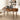 Wooden desk with laptop, lamp, and office supplies in a home office setting.