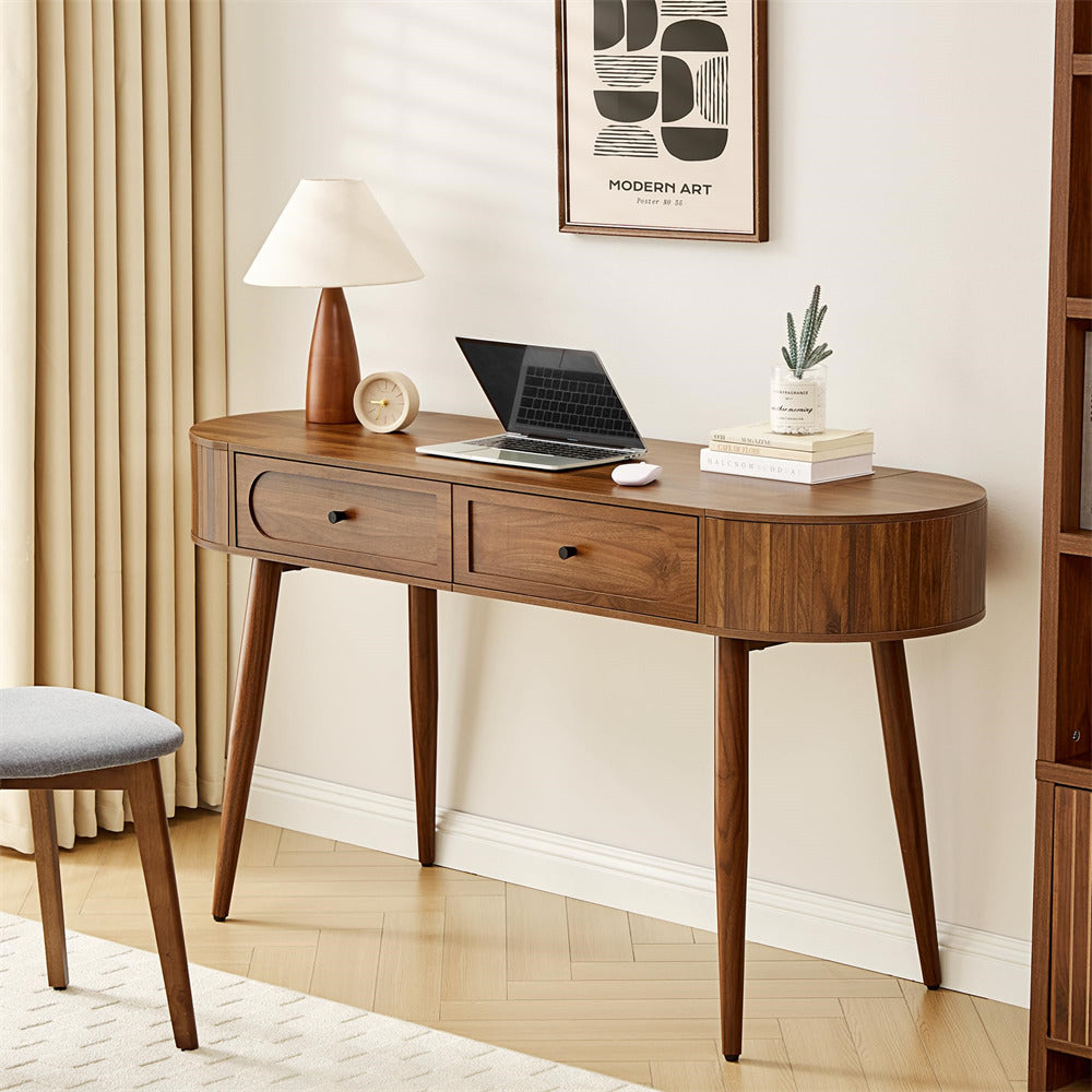 Wooden desk with laptop, lamp, and decor in a home office setting