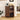 Wooden kitchen cabinet with coffee maker and supplies on a wooden floor.