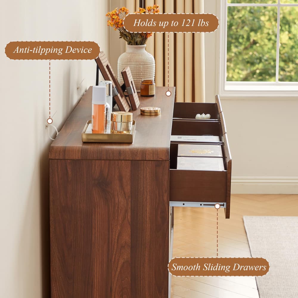 A dark brown wooden writing desk or credenza shown in a styled room with a window, curtains, and decor. The image includes callout text labels pointing to features: an anti-tip device, smooth sliding drawers, and weight capacity up to 121 lbs.
