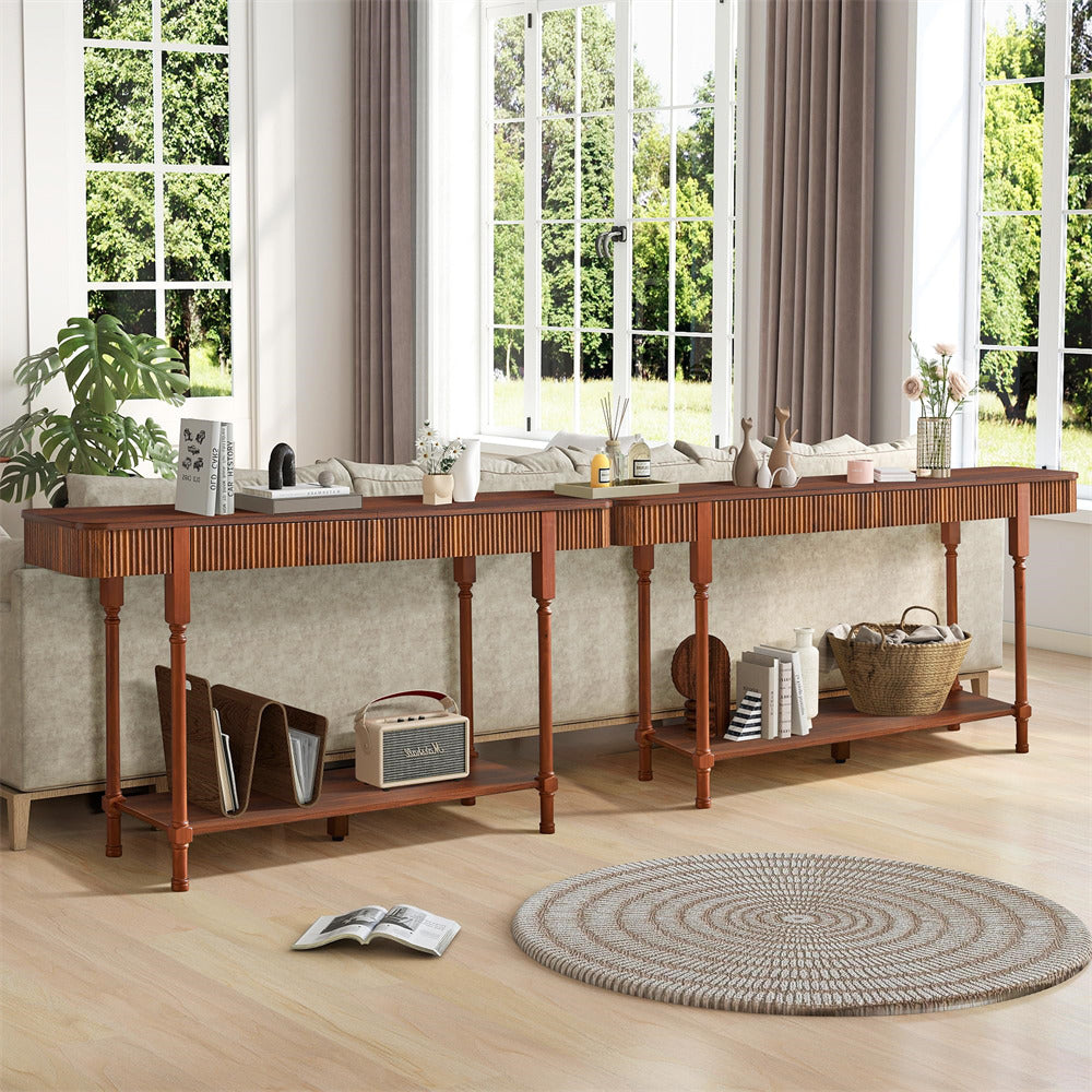 Long wooden console table in a living room with decor items and a rug.